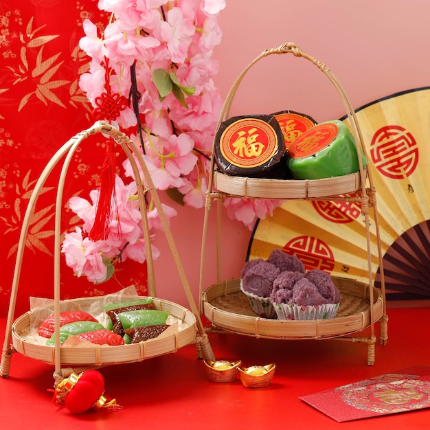 Imlek Chinese New Year Cake, Nian Gao or Kue Keranjang, Fa Gao or Steamed Cupcake, Kue Ku or Angku, and Steamed Sticky Rice Cake or Wajik. Red Concept. Chinese Character is "Fu' means Fortune
