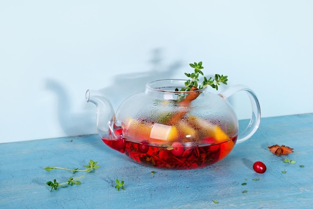 Immunity boosting drink winter tea with cranberries orange\
hibiscus and spices in glass teapot