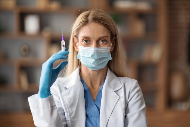 Immunization Concept Doctor Lady In Medical Mask Holding Syringe With Vaccine Dose