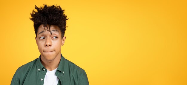 Impatient african american young man looking at copy space