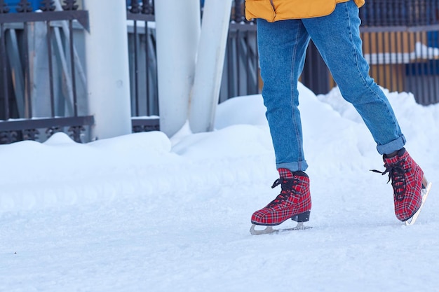 Impersonal legs of a woman skating on a winter day. Copy space