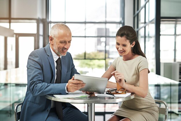 Important decisions need to be made Cropped shot of two businesspeople working together on a digital tablet in a modern office