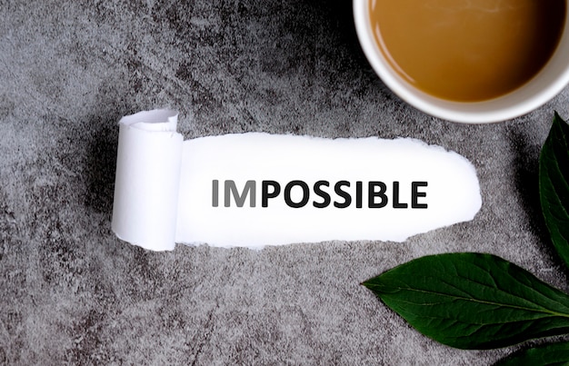 Impossible with cup of coffee and green leaf