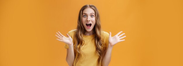 Impressed excited girl describing feelings sharing positive impression gesturing with palms during