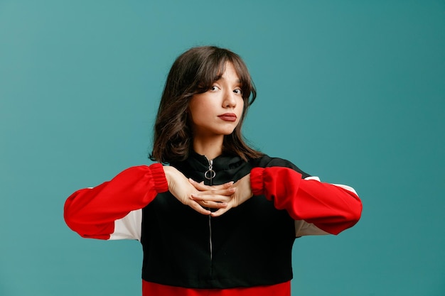 Impressed young caucasian woman keeping hands together looking at camera isolated on blue background