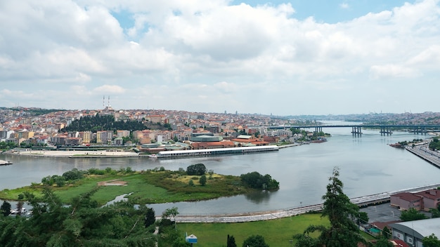 Impressive panoramic view of bay with waterfront against cultural capital with skyscrapers under cloudy sky