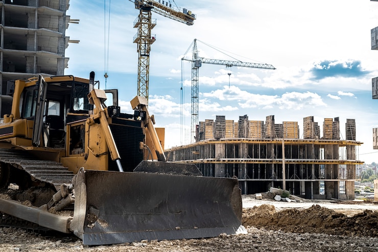 Foto in aanbouw op een achtergrond van blauwe lucht en nieuwe gebouwen is een vrachtkraan. bouwconcept