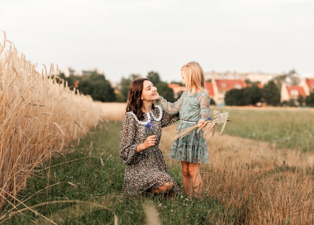 In de zomer wandelen oudere en jongere zussen samen in de natuur. zus knuffelt en kalmeert