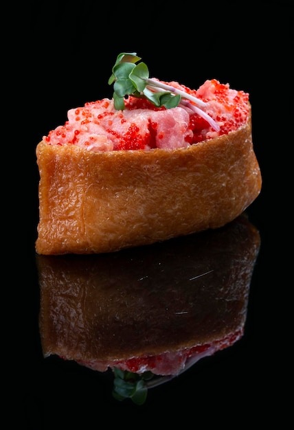 Inari sushi tuna on glossy black background