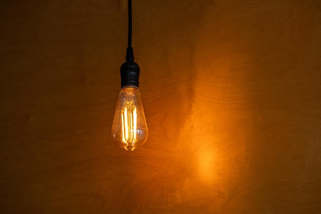 Incandescent lamp on the background of a yellow wall