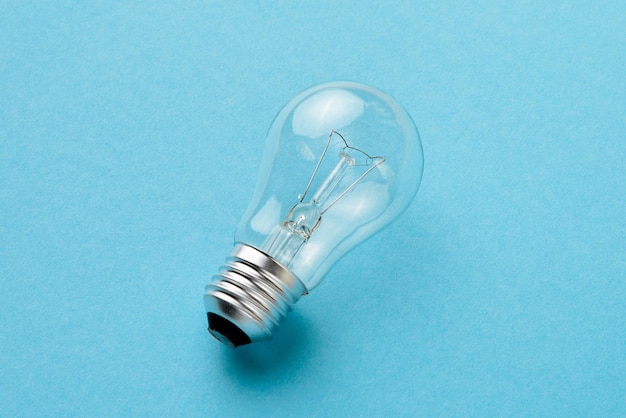 Incandescent lamp isolated on blue background closeup