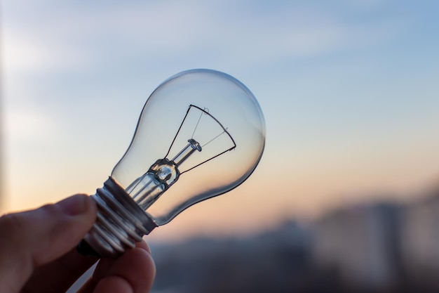 Incandescent lamp on sunset background