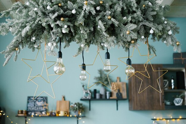 Foto lampade a incandescenza tra la ghirlanda di natale nella cucina decorata per natale e capodanno