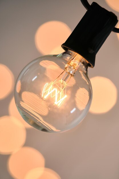 Incandescent light bulb with christmas round bokeh