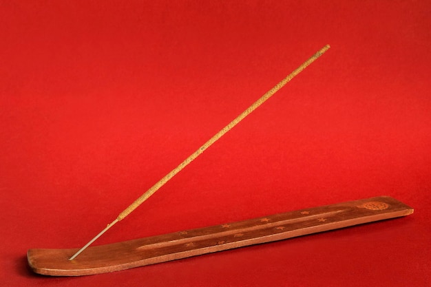 Incense stick on red background