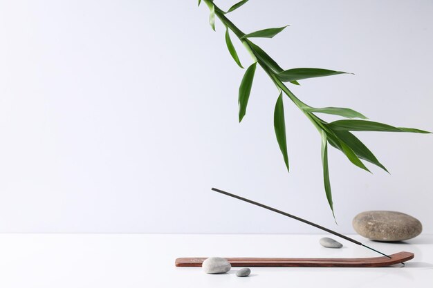 Incense stick stones and bamboo on white background space for text