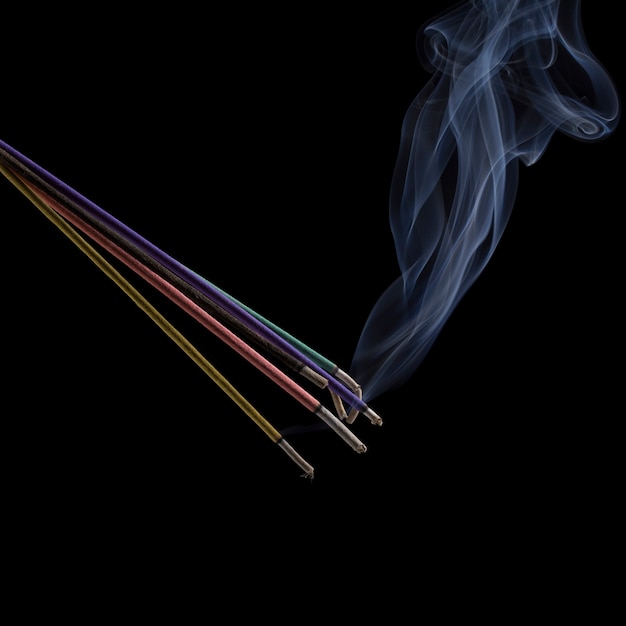 Incense sticks on black