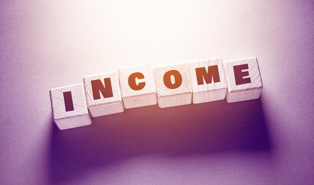 Income Word Written on Wooden Cubes