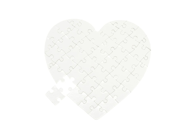 Incomplete jigsaw puzzle in a shape of a heart isolated on white