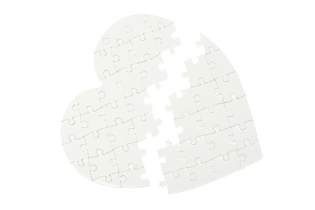 Incomplete jigsaw puzzle in a shape of a heart isolated on white