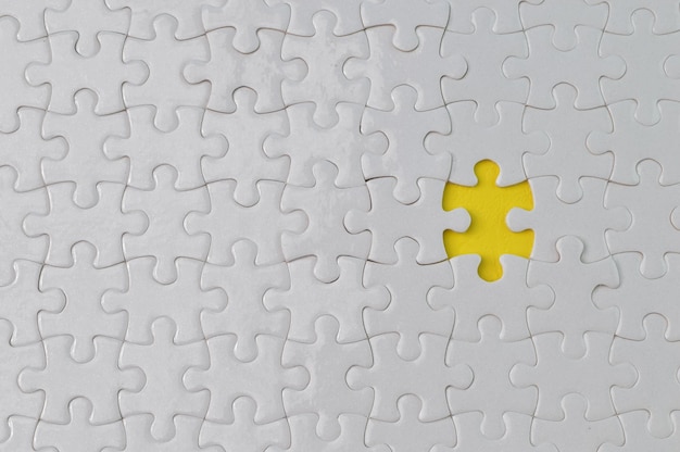 Incomplete white jigsaw puzzle pieces Flat lay view