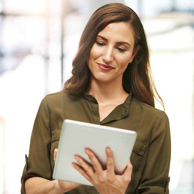 Increasing her business productivity with technology Cropped shot of a young businesswoman using a digital tablet in an office