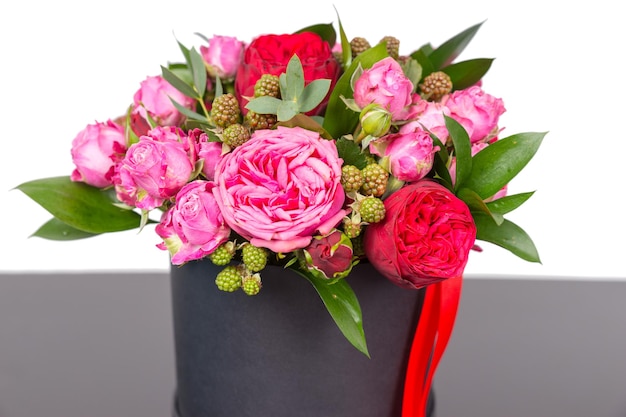 Incredible bouquet of pink roses and red ribbon in a concept of love, romance, anniversary, Valentines day or wedding