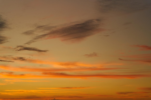 Incredible colors of the sunset sky with marshmallow clouds over the ocean