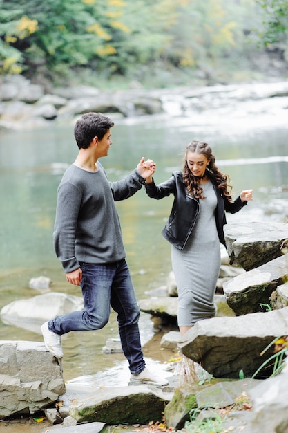 incredibly beautiful and lovely couple on the mountain river