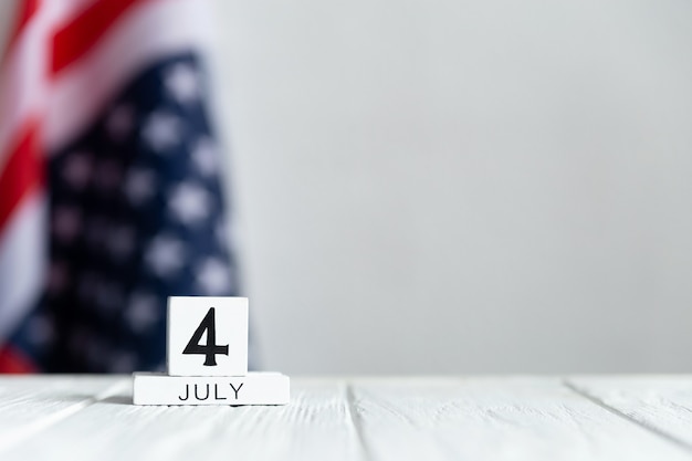 Independence day, the fourth of july, calendar on the us flag
background and white wood table