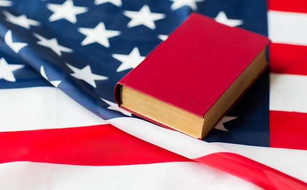 写真 独立記念日、愛国心、公民権、文化的価値観、ナショナリズムのコンセプト – アメリカの国旗と憲法の本や聖書の接写