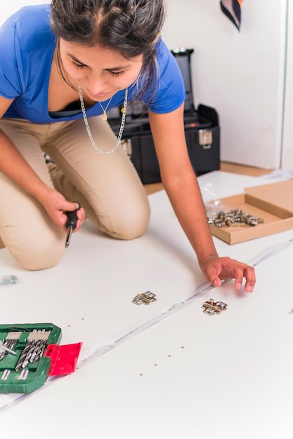 Independent and success Bolivian Latin woman assembly and fix repair in moving house