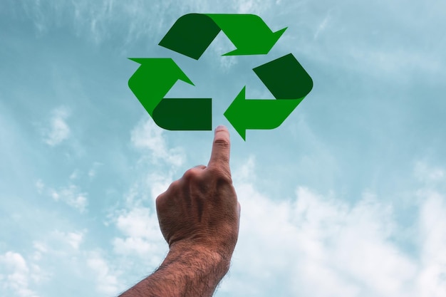 index finger pointing to the recycling symbol