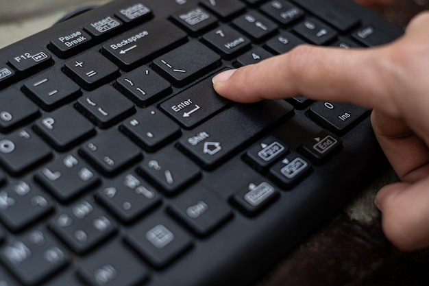 Index finger push button Enter on the computer keyboard