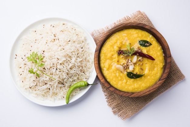 Indiaas populair eten Dal fry of traditionele Dal Tadka Curry geserveerd met jeera rijst, geïsoleerd op witte achtergrond, selectieve focus