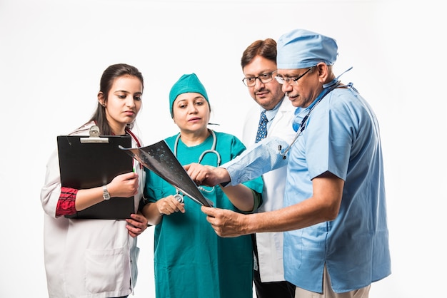 Indian asian doctors looking an x-ray or MRI , isolated over white background. selective focus