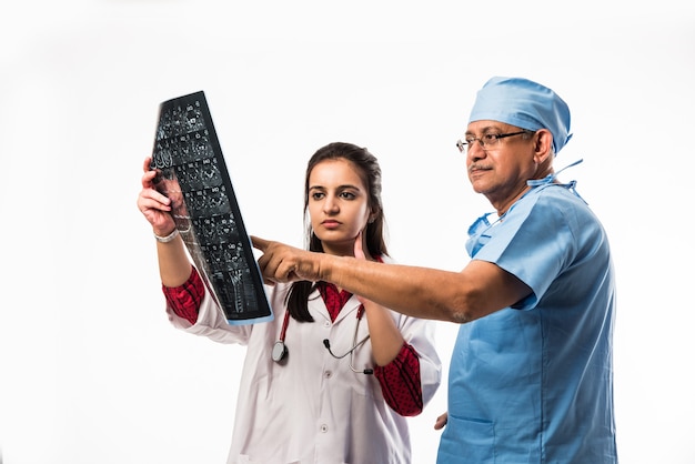 Indian asian doctors looking an x-ray or MRI , isolated over white background. selective focus