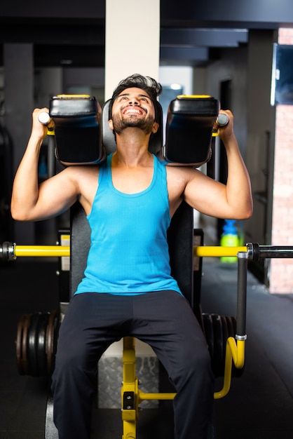 Indian asian handsome man working out or exercising in the gym - Health and fitness concept