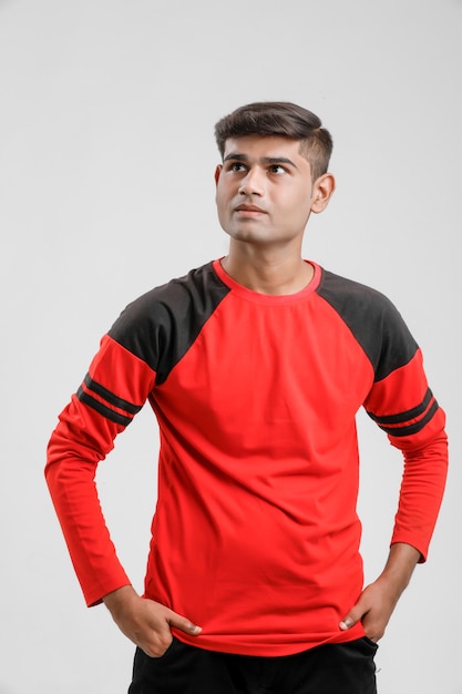 Indian / Asian man in red T-shirt and showing multiple expression over white 