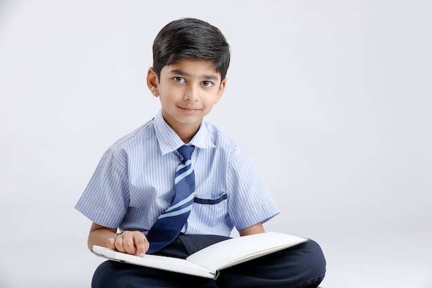 Indian / Asian school boy with note book and studying