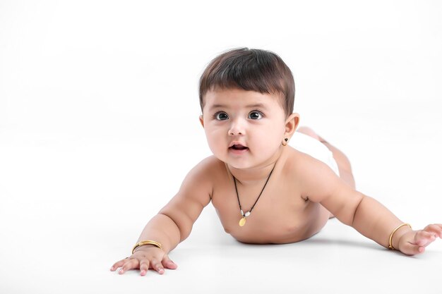 Indian baby girl playing on white background