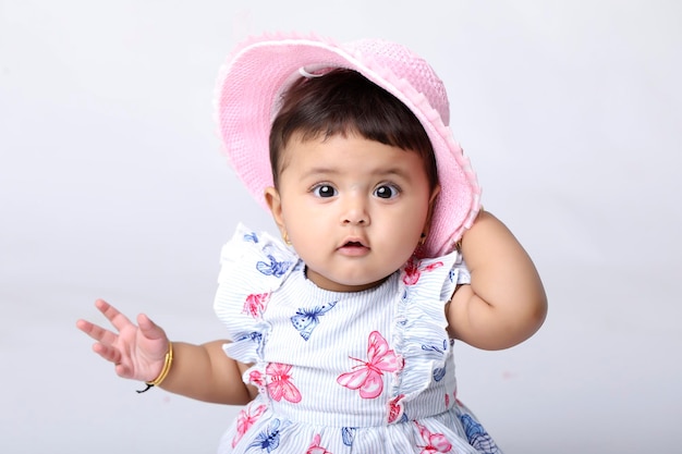 Indian baby girl sitting on white background