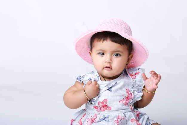 Indian baby girl sitting on white background