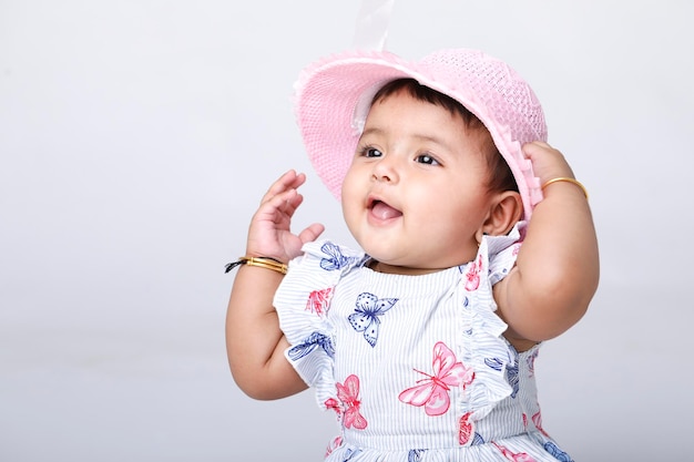 Indian baby girl sitting on white background