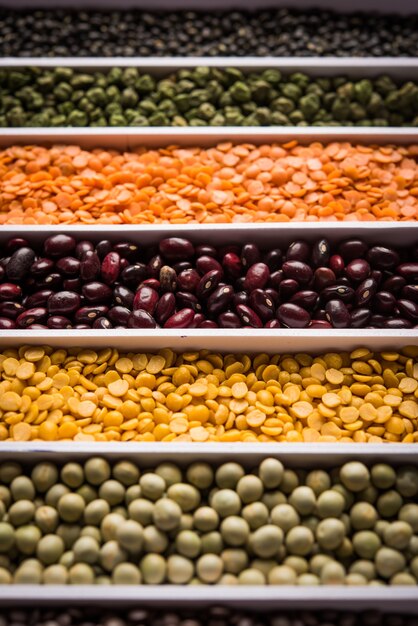 Indian Beans,Pulses,Lentils,Rice and Wheat grain in a white box with cells or strips, selective focus.