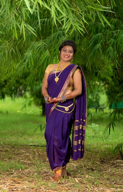 Image of Indian traditional Beautiful Woman Wearing an traditional Saree  And Posing On The Outdoor With a Smile Face-PS102468-Picxy