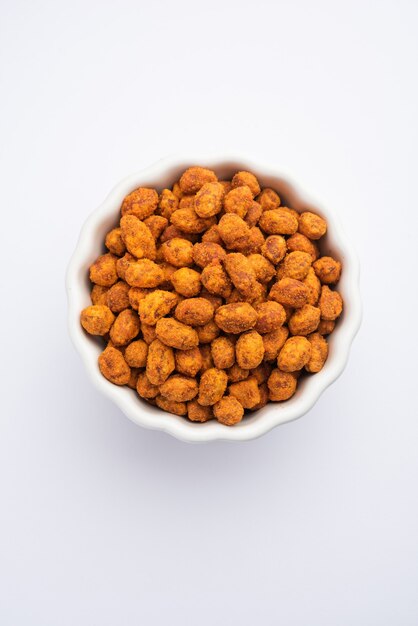 Indian besan coated crunchy and spicy masala peanuts or mungfali served in a bowl or plate