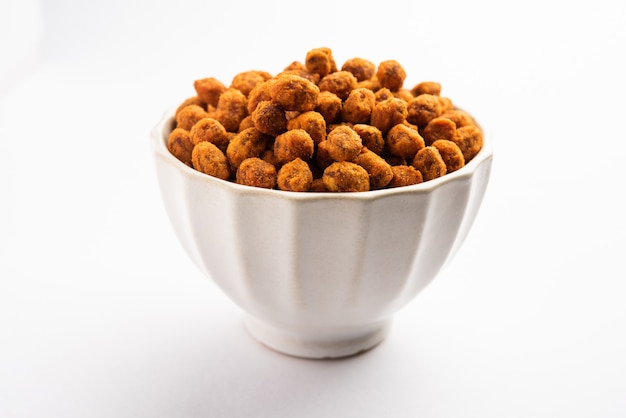 Indian besan coated crunchy and spicy masala peanuts or mungfali served in a bowl or plate