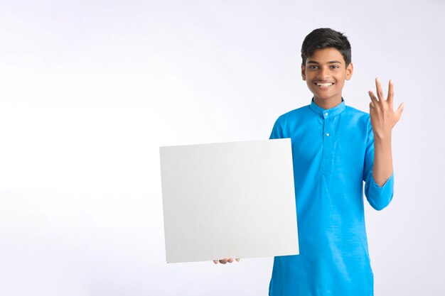 Indian boy showing white board with copy space on white background