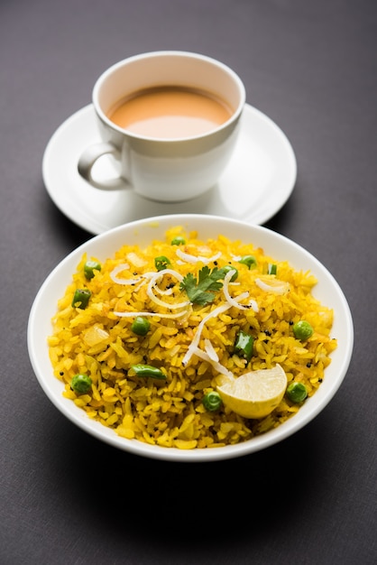 Indian Breakfast Dish Poha Also Know as Pohe or Aalu poha made up of Beaten Rice or Flattened Rice. The rice flakes are lightly fried in oil with spices served with hot tea